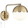 Kelowna Antique Brass and Glass Globe Swing Arm Plug-In Wall Lamp in scene