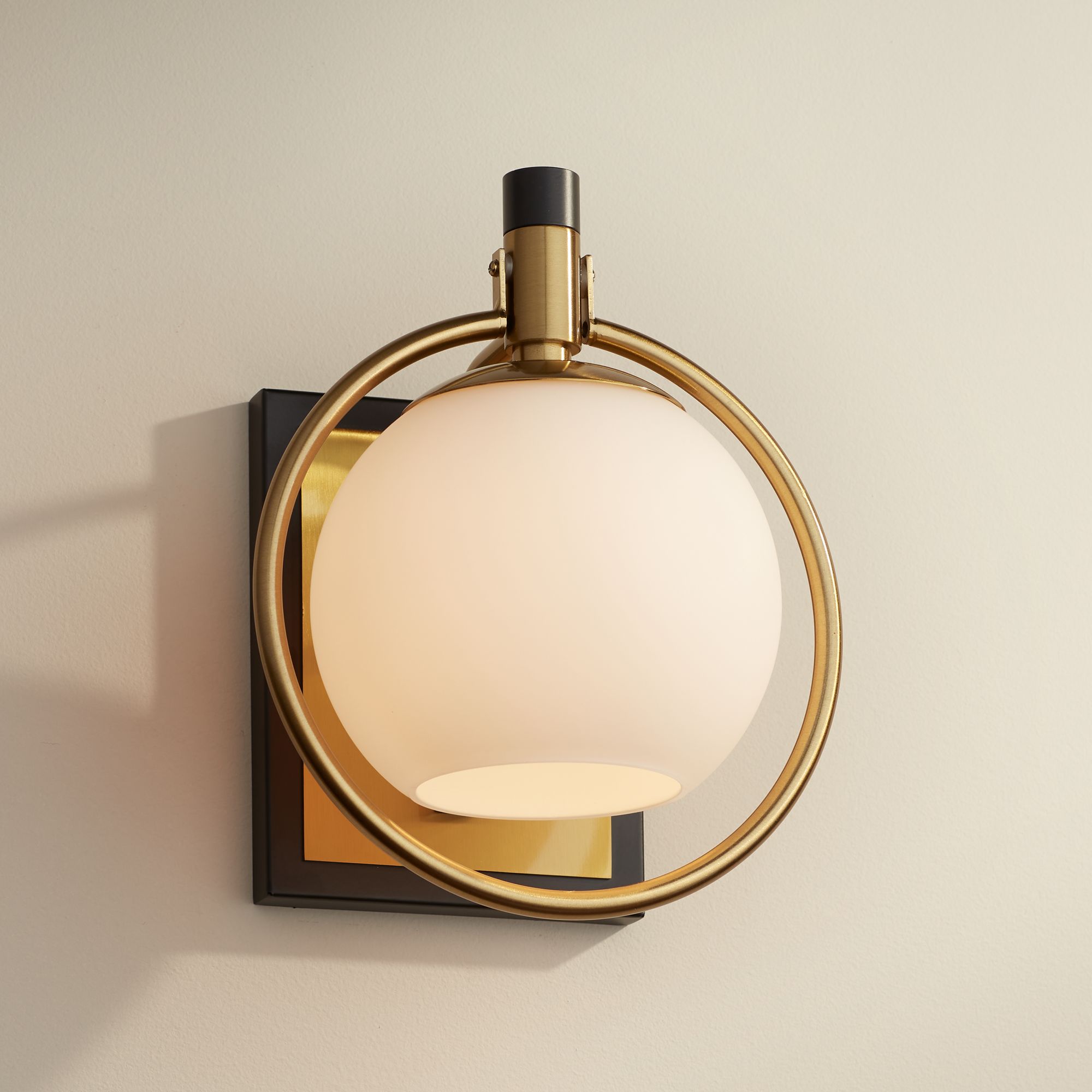 Watch A Video About the Possini Euro Carlyn Antique Brass and Black Wall Sconce