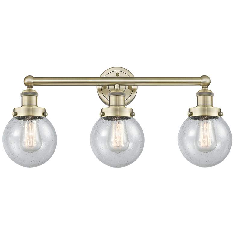 Image 1 Small Edison Beacon 24.5"W 3 Light Antique Brass Bath Light w/ Seedy S