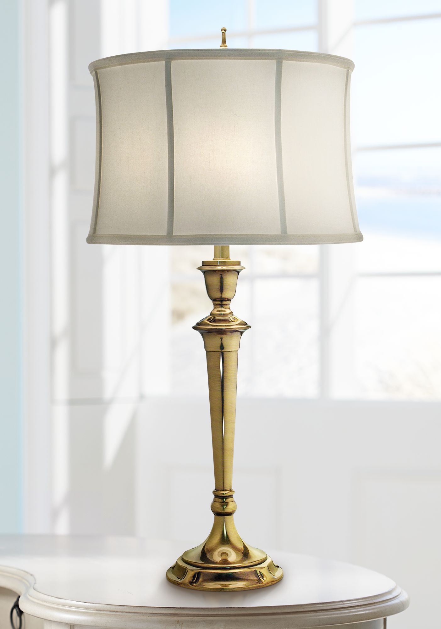 white and brass table lamp