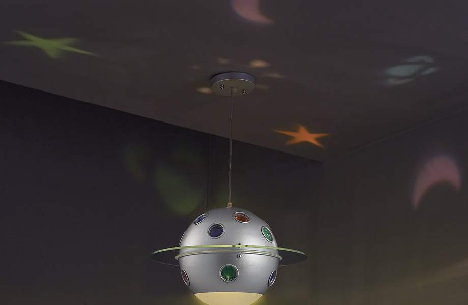 In A Child S Bedroom A Ceiling Light Projects Stars And