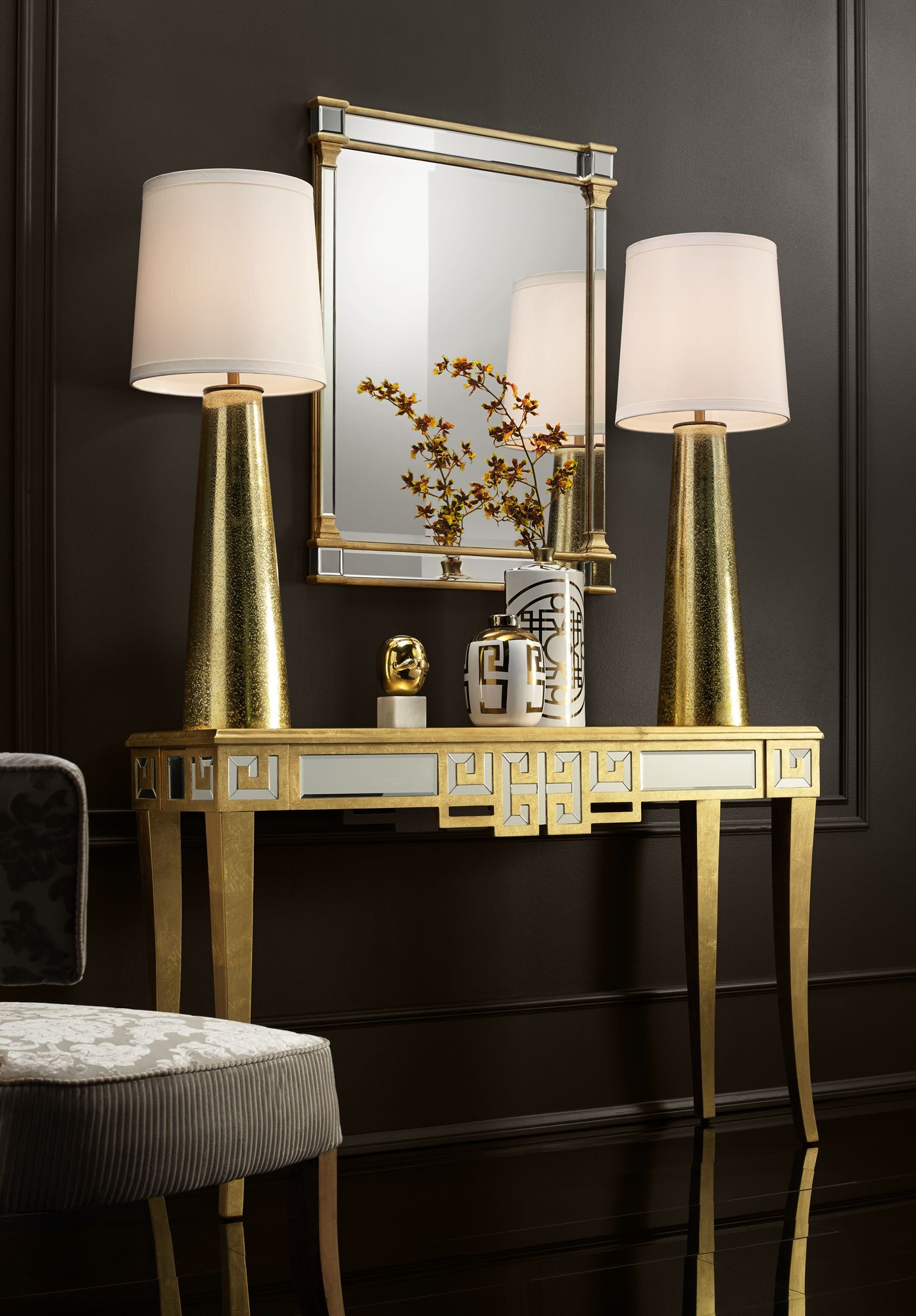 Tall gold finish table lamps create drama in an entryway. Lamps Plus