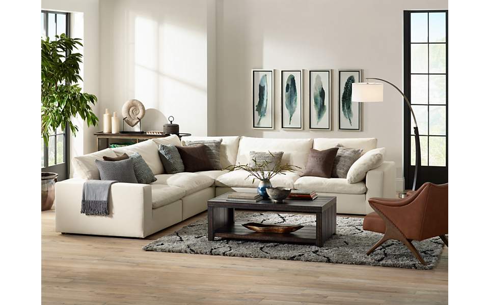 Comfy sectional seating is paired with an arc floor lamp in this living ...